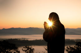 Silhouette of christian man hand praying,spirituality and religion,man praying to god. Christianity concept.